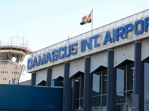 This file photo taken on October 1, 2020 shows the Syrian flag flying at Damascus International Airport outside Syria's capital.