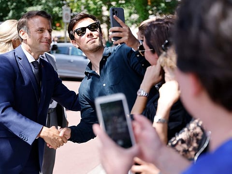 France's President Emmanuel Macron meets residents after voting in the first round of French parliamentary election in Le Touquet, northern France, Sunday June 12, 2022.