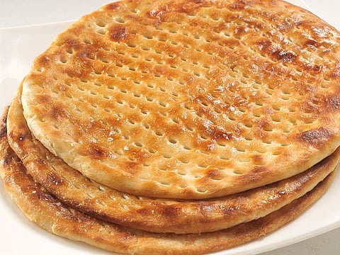 Sheermal - A soft round bread, mildly sweetened with scents of rose water and saffron with its iconic holes