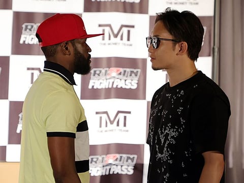 Boxer Floyd Mayweather Jr. (left) and mixed martial artist Mikuru Asakura face off during a news conference announcing their exhibition boxing bout at The M Resort in Henderson, Nevada. The bout will take place in September 2022 in Japan as part of a RIZIN Fighting Federation show.