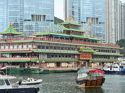 Hong Kong's Jumbo Floating Restaurant, an iconic but aging tourist attraction designed like a Chinese imperial palace, is towed out of Aberdeen Harbour on June 14, 2022, after years of revitalisation efforts went nowhere. (Photo by Peter PARKS / AFP)