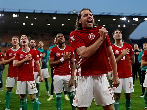 Hungary’s striker Adam Szalai (C) leads the celebrations as Hungary’s players celebrate in front of their supporters after beating England 4-0 in the UEFA Nations League.