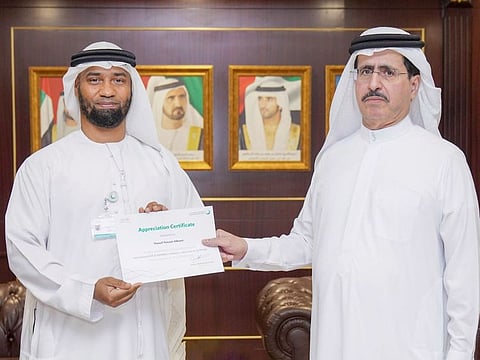 Saeed Mohammed Al Tayer honours Dewa employee and innovator Yousuf Hassan Alburei for winning the golden award at the International Invention, Innovation and Technology Exhibition 2022.