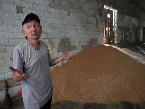 Farmer Serhiy stands near a mound of grain in his barn in the village of Ptyche in eastern Donetsk region, Ukraine, on June 12, 2022. Russian hostilities in Ukraine are preventing grain from leaving the “breadbasket of the world" and making food more expensive across the globe, raising the spectre of shortages, hunger and political instability in developing countries.