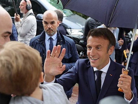 French President Emmanuel Macron greets supporters as he leaves after voting in the second round of French parliamentary elections, at a polling station in Le Touquet-Paris-Plage, France, June 19, 2022.