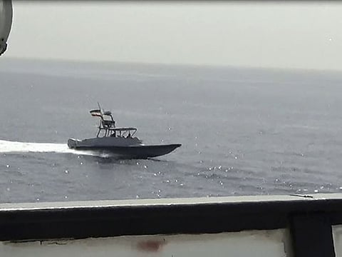 In this image from a video made available by the US Navy, a boat of Iran's Islamic Revolutionary Guard Corps Navy (IRGCN) operates in close proximity to patrol coastal ship USS Sirocco (PC 6) and expeditionary fast transport USNS Choctaw County (T-EPF 2) in the Strait of Hormuz, Monday, June 20, 2022. A U.S. Navy warship fired a warning flare to wave off an Iranian Revolutionary Guard speedboat coming straight at it during a tense encounter in the strategic Strait of Hormuz, officials said Tuesday. (U.S. Navy via AP)