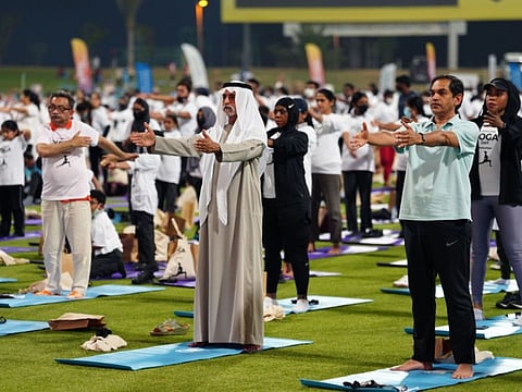 Sheikh Nahyan bin Mubarak Al Nahyan, UAE Minister of Tolerance and Coexistence, and Sunjay Sudhir, Indian Ambassador to the UAE, taking part in the International Day of Yoga Common Protocol at the Zayed Cricket Stadium in Abu Dhabi on Tuesday.