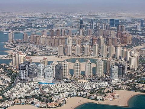 Residential and commercial skyscrapers on the city shoreline in Doha, Qatar.