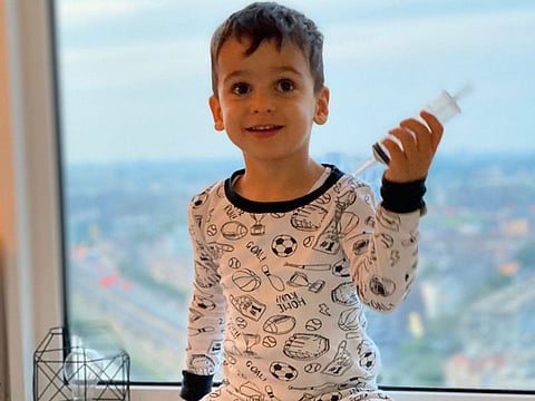 Eray, while on a holiday in Rotterdam - the Netherlands, a month before the family's move to Dubai. He was still partly tube fed and a feeding syringe was his favorite toy, says his mum.