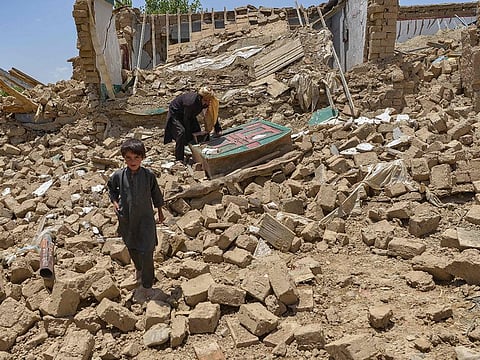 File photo: Afghan people look for their belongings amid the ruins of a house damaged by an earthquake in Bernal district, Paktika province, on June 23, 2022.