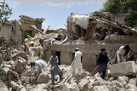 Afghan men search for survivors amidst the debris of a house that was destroyed by an earthquake in Gayan, Afghanistan, June 23, 2022.
