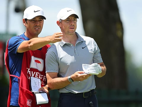Rory McIlroy of Northern Ireland and caddie Harry Diamond prepare to tee off on the ninth tee during the first round of Travelers Championship at TPC River Highlands in Connecticut on Thursday.
