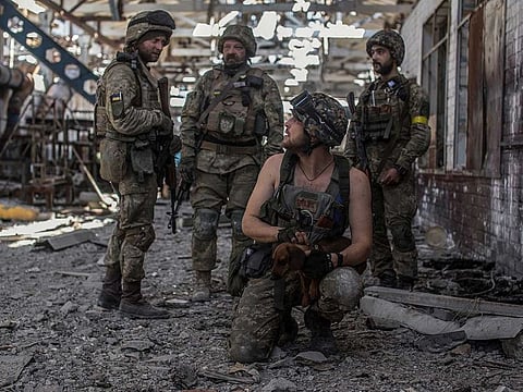 Ukrainian service members speak to each other in the industrial area of the city of Sievierodonetsk, as Russia's attack on Ukraine continues, June 20, 2022.