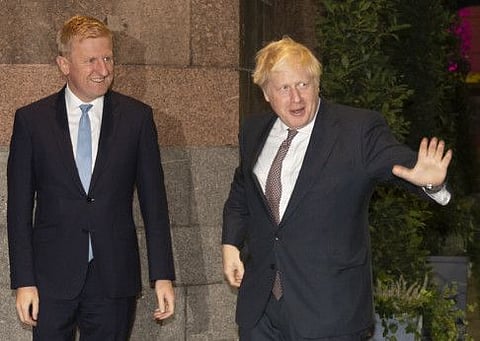 Britain's Prime Minister Boris Johnson, right, stands alongside Conservative Party Chairman Oliver Dowden as he arrives for the Conservative Party Conference in Manchester, England, Saturday, Oct. 2, 2021. Party chairman Oliver Dowden quit Friday June 24, 2022 in the wake of two special election defeats for British Prime Minister Boris Johnson's Conservative party.