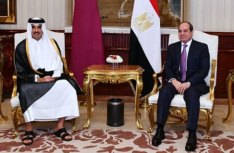 A handout picture released by the Egyptian Presidency shows President Abdel Fattah Al Sissi welcoming the Emir of Qatar Sheikh Tamim bin Hamad Al Thani in Cairo on June 24, 2022.