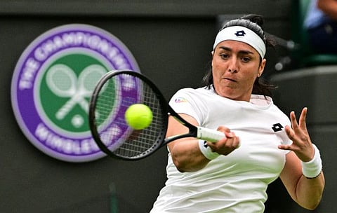 Tunisia's Ons Jabeur returns the ball to Sweden's Mirjam Bjorklund during their women's singles tennis match on the first day of the 2022 Wimbledon Championships at The All England Tennis Club in Wimbledon, southwest London.