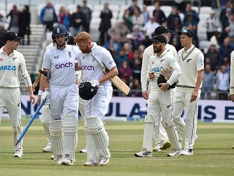 England's Joe Root, (second left) carries a stump as he leaves the field with batting partner Jonny Bairstow after their win on the fifth day of the third Test match against New Zealand at Headingley in Leeds, England.