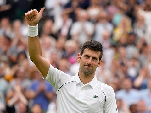 Serbia's Novak Djokovic celebrates after beating Korea's Kwon Soon-woo in a men's singles first round on day one of the Wimbledon Championships in London on Monday.