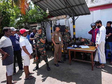 Army soldiers register people who are waiting to buy fuel at a fuel station in Colombo, Sri Lanka, Monday, June 27, 2022.