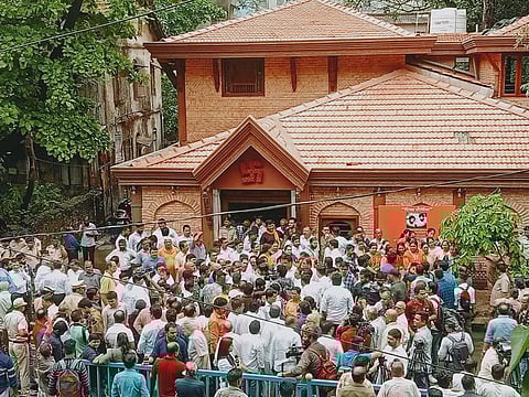 Supporters of Rebel Shiv Sena leader Eknath Shinde gather outside Anand Ashram as they stage a demonstration in his support, in Thane on Monday, June 27, 2022.