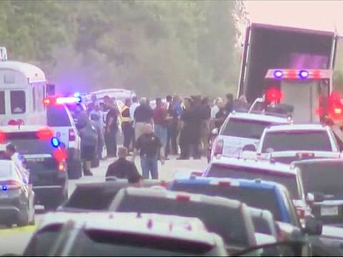 Law enforcement officers work at the scene where dozens of people were found dead inside a trailer truck in San Antonio, Texas, U.S. June 27, 2022 in a still image from video.