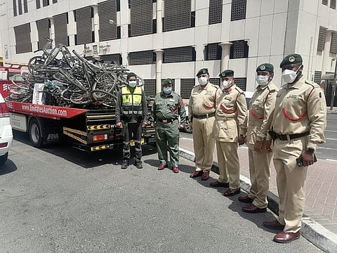 Dubai Police personnel with the seized bicycles.