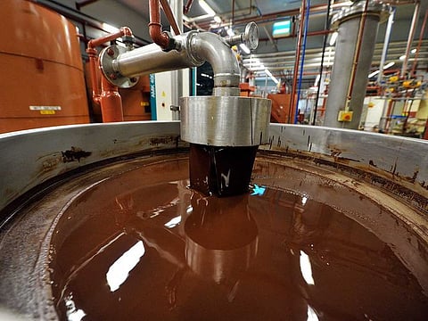 This file photograph taken on July 8, 2013, shows hot chocolate before being moulded at the Barry Callebaut chocolate factory in Wieze, eastern Flanders.
