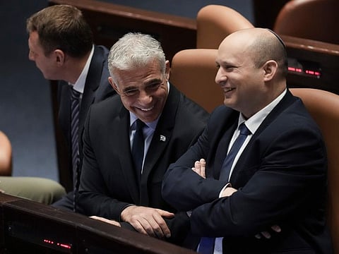 Israeli Prime Minister Naftali Bennett, right, and Foreign Minister Yair Lapid ahead of the vote on a bill to dissolve parliament, at the Knesset, Israel's parliament, in Jerusalem, on June 30, 2022.