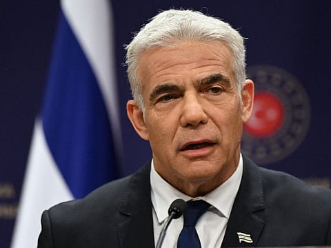 Israeli Foreign Minister Yair Lapid speaks during a press conference in Ankara, on June 23, 2022. As caretaker prime minister after parliament dissolved itself on Thursday, the still-chiseled but now gray-haired Lapid may have to reach out more widely to maintain a stable government and win a November 1 election on his own merits