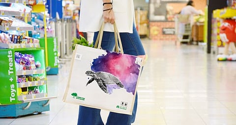 A shopper with a reusable shopping bag at a hypermarket in Dubai.