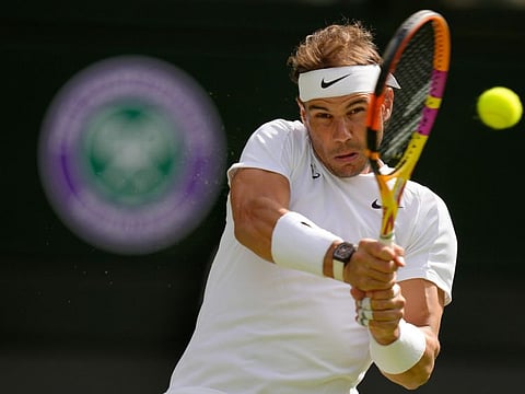 Spain's Rafael Nadal hits a double-fisted backhand return during his four-set win over Lithuania's Ricardas Berankis at the All England Club in London on Thursday.