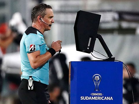 Argentine referee Patricio Loustau checks the VAR and disallows a goal during the Copa Sudamericana tournament. According to Fifa the VAR has helped reduce errors and now the world governing body is moving to semi-automated off-side technology.