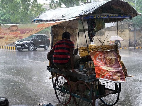 A roadside vendor takes shelter on his cart during heavy monsoon rains in Prayagraj, in the northern Indian state of Uttar Pradesh, Saturday, June. 25, 2025.
