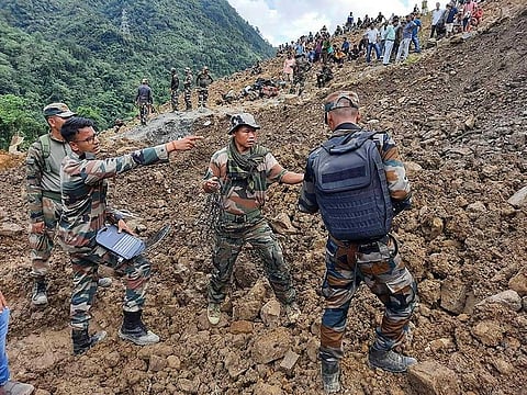 In this handout photo released by the Indian Army and taken on July 2, 2022, soldiers and disaster relief teams search for survivors and victims after a landslide in Noney district, some 50 Km from Manipur's capital Imphal.