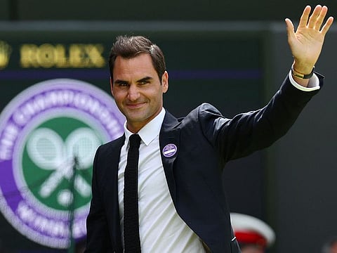 Swiss tennis player Roger Federer waves during the Centre Court Centenary Ceremony, on the seventh day of the 2022 Wimbledon Championships at The All England Tennis Club in Wimbledon, southwest London.