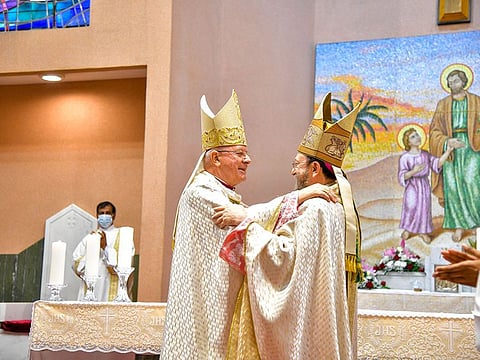 Bishop Paolo Martinelli being greeted by his predecessor Bishop Paul Hinder,