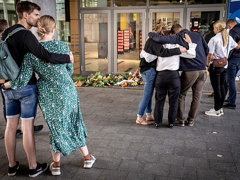 People pay their respects at the entrance to the Field's shopping centre in Copenhagen, on July 4, 2022.