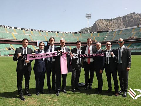 New outlook: Top officials of Palermo and City Football Group line up for a photo-op after the Italian club became a part of the City stables on Monday.