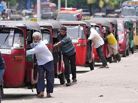 Auto rickshaw drivers line up to buy gas near a fuel station in Colombo, Sri Lanka.