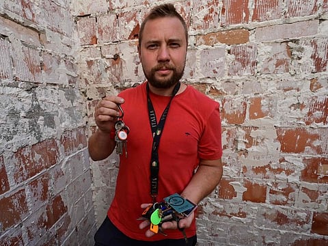 Biologist and gardener Yevgen Yelpitiforov, 37, shows the keys of houses and apartments entrusted to him by people who fled the war, in Irpin, Kyiv region, on July 1, 2022.