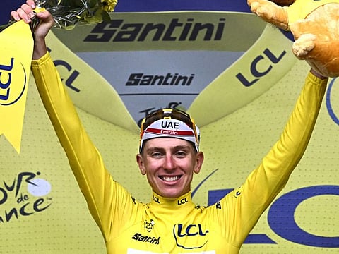 UAE Team Emirates' Tadej Pogacar celebrates on the podium wearing the overall leader's yellow jersey after the sixth stage of the 109th Tour de France on Thursday.