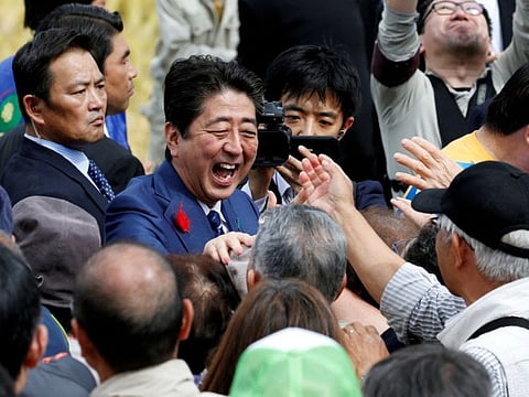 Japan's Prime Minister Shinzo Abe, who is also ruling Liberal Democratic Party leader, shakes hands with his supporters after an election campaign rally in Fukushima, Japan, October 10, 2017.