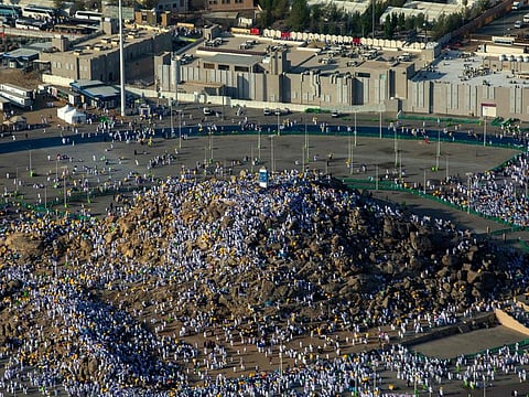 An aerial view shows Muslim pilgrims gathering atop Mount Arafat, also known as Jabal al-Rahma (Mount of Mercy), southeast of the holy city of Mecca, during the climax of the Hajj pilgrimage, on July 8, 2022.