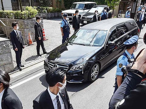 A hearse transporting the body of former Japanese prime minister Shinzo Abe arrives at his residence in Tokyo on July 9, 2022.