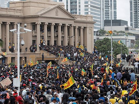 Flashpoint: Sri Lankan protesters celebrate after entering into the Presidential Secretariat after President Gotabaya Rajapaksa's exit amid the country's economic crisis in Colombo on Saturday.