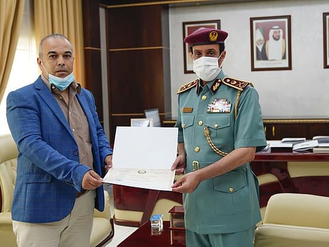 Dr. Jamal Ahmed Ibrahim Al Sharqawi being honoured by the Ajman Police for his assistance to inmates.