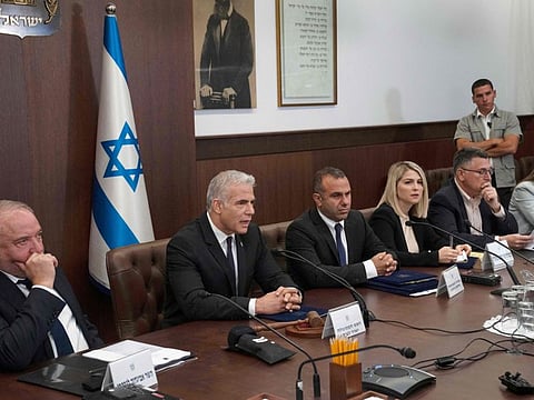 Israeli Prime Minister Yair Lapid (2nd left) makes a statement at the start of the weekly cabinet meeting in Jerusalem, on July 10, 2022.