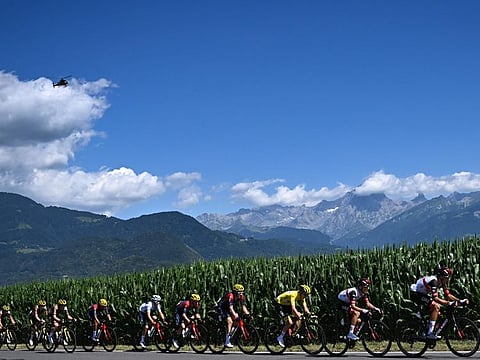 UAE Team Emirates team's Slovenian rider Tadej Pogacar wearing the overall leader's yellow jersey (third from right) cycles with the pack of riders during the ninth stage of the 109th edition of the of the Tour de France on Sunday.