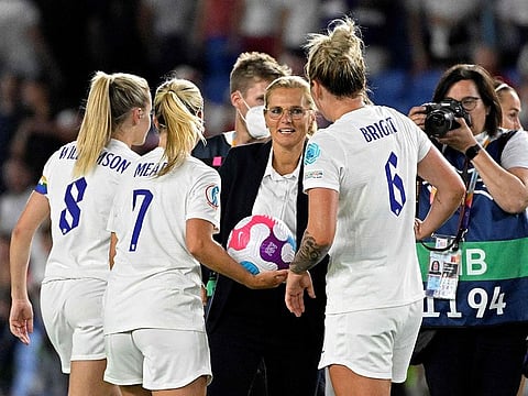 England's coach Sarina Wiegman (centre) contratulates midfielder Leah Williamson (left), triker Beth Mead (centre left) and defender Millie Bright after the UEFA Women's Euro 2022 Group A football match against Norway at Brighton and Hove Community Stadium in Brighton, Southern England.