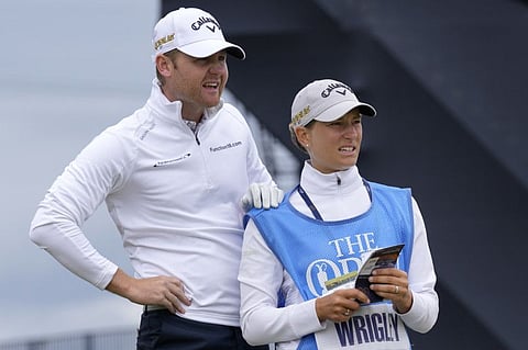 England's golfer Alex Wrigley (left) supported by his wife Johanna Gustavsson during a practice round at the British Open golf championship in St Andrews, Scotland. The Open Championship returns to the home of golf on July 14-17, 2022, to celebrate the 150th edition of the sport's oldest championship, which dates to 1860 and was first played at St. Andrews in 1873.